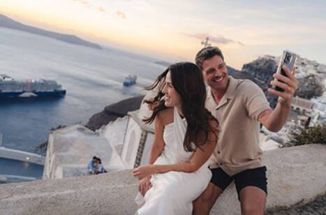 A couple taking a photo in front of Celebrity Ascent