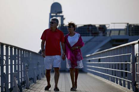A couple walking on a cruise ship deck