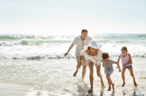 A family playing in the sea together on a Caribbean beach