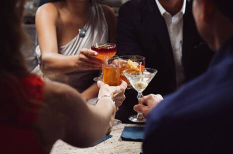 A group of people with their drinks in Crown Grill on Enchanted Princess