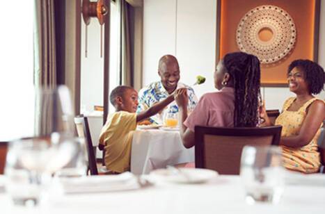 A family of four sitting together at a dinner table