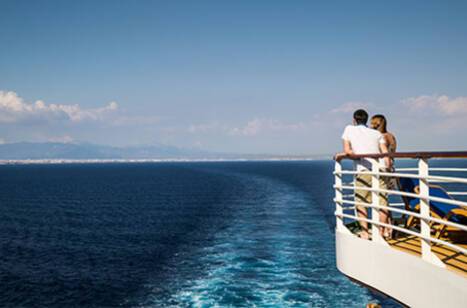 A couple on deck of Azura during sail away