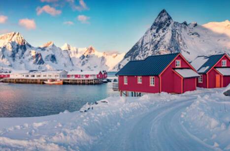 Panoramic image of a small, snow-covered fishing town in Norway