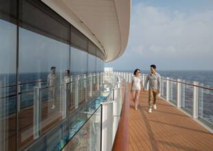 A couple walking along the Promenade Deck on P&O Cruises ship Iona