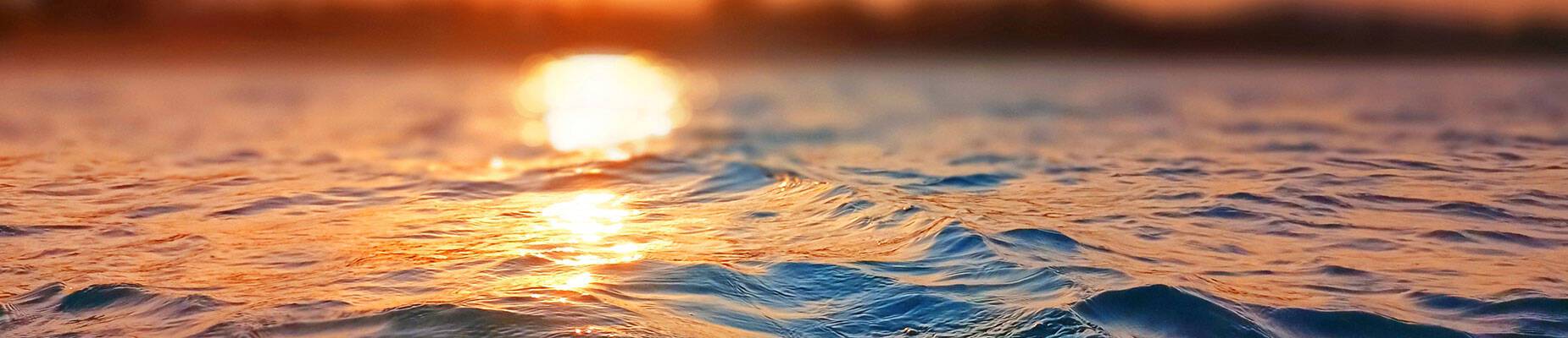 Sun setting over a body of water