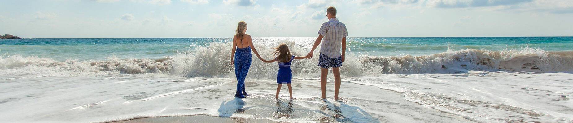 A family of three splashing around in the sea