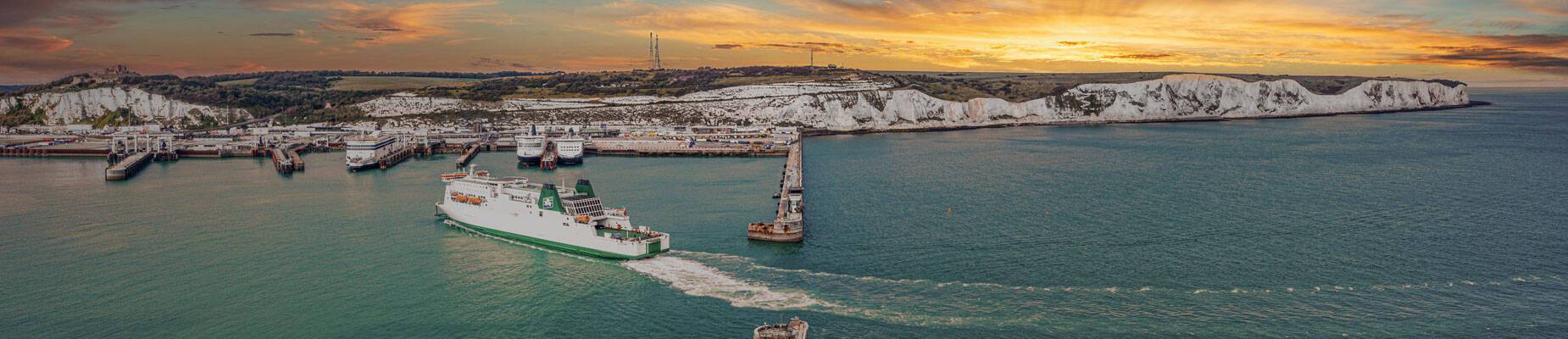 Panoramic image of White cliffs of Dover and cruise terminal at sunset
