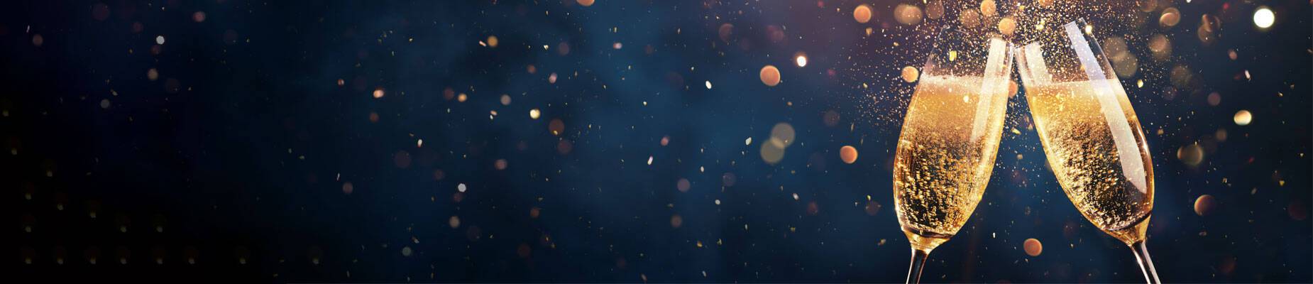 Two champagne glasses clinking