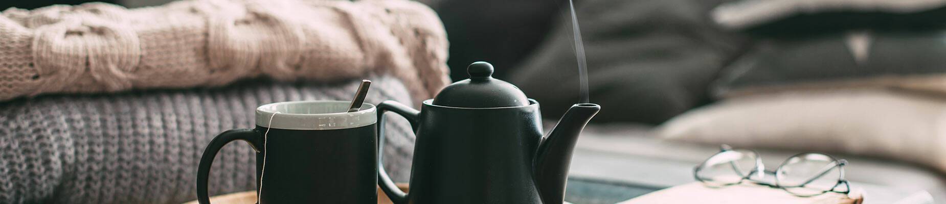 Teapot and mug on a coffee table