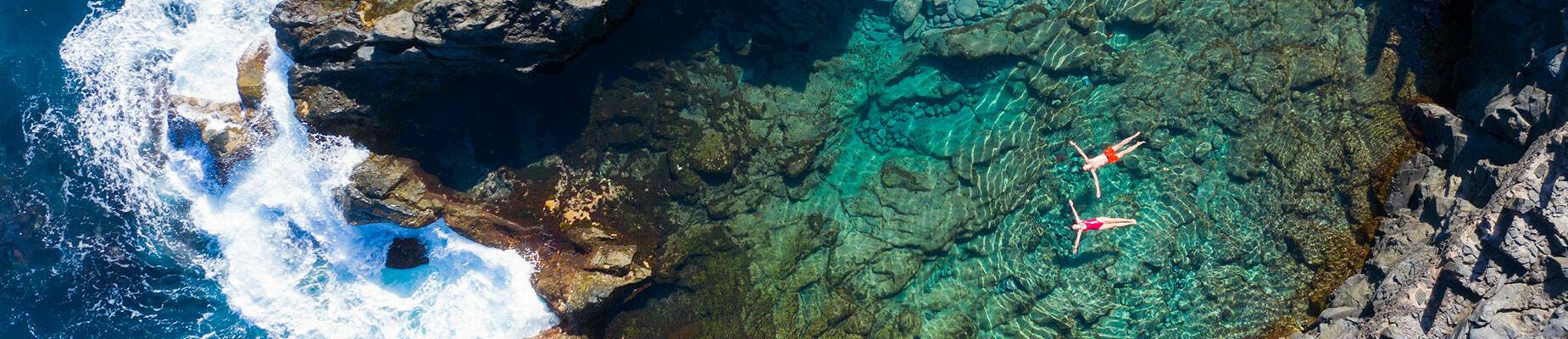 Two people floating on their backs in the sea