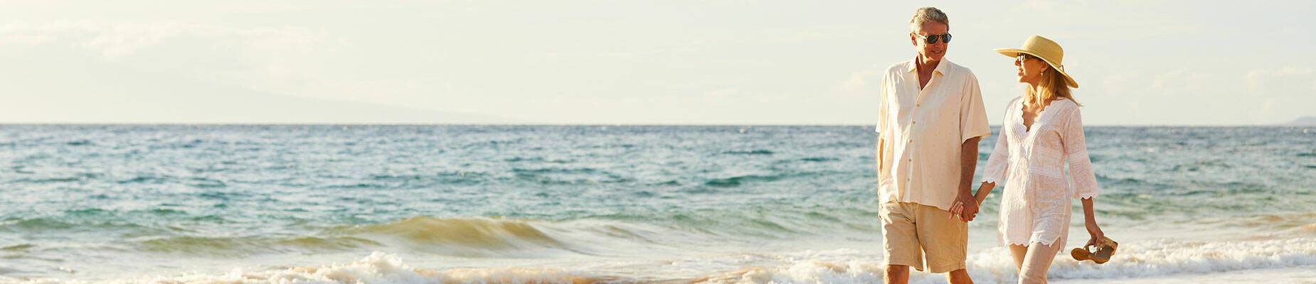 Couple walking hand in hand on the beach