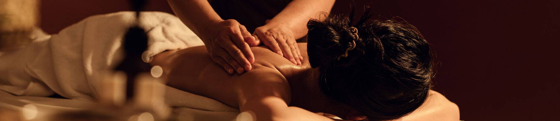 Panoramic image of a woman having a massage in a spa at sea