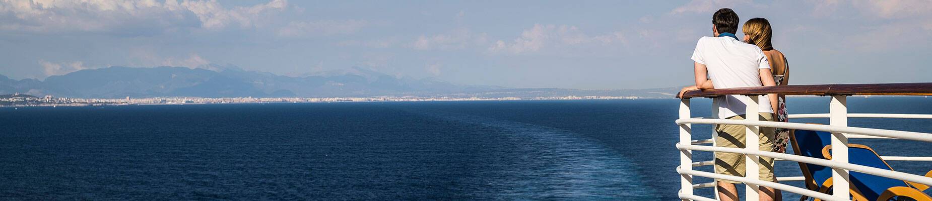 A couple on deck of Azura during sail away