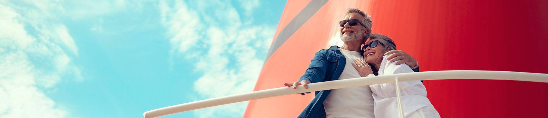 A couple standing by the funnel on a Cunard ship