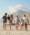 A multigenerational family walking along a beach