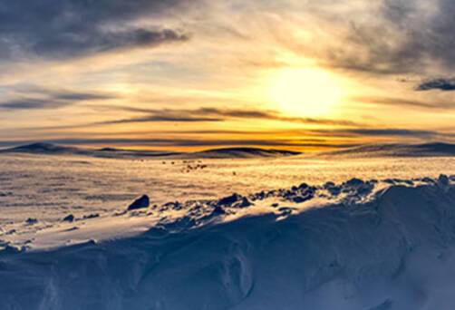 A snowy road into Alta at sundown
