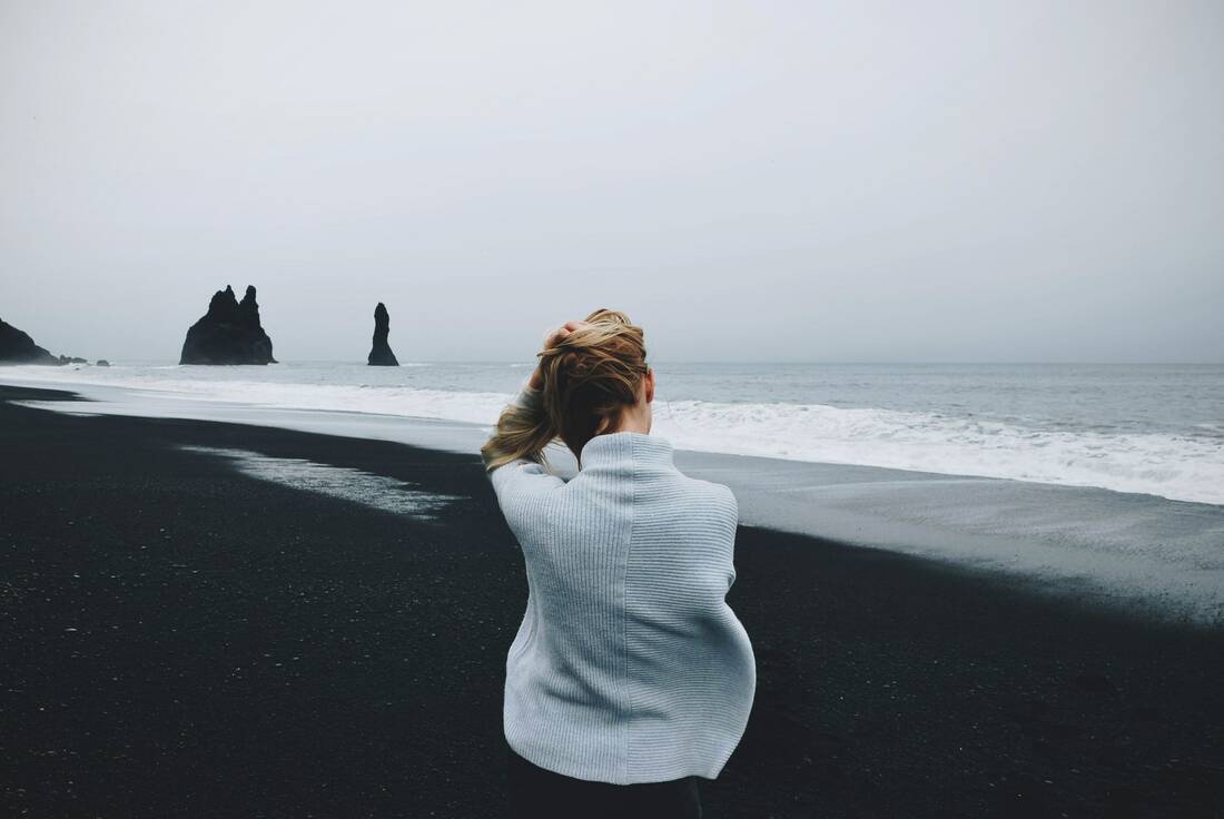woman on black sand beach