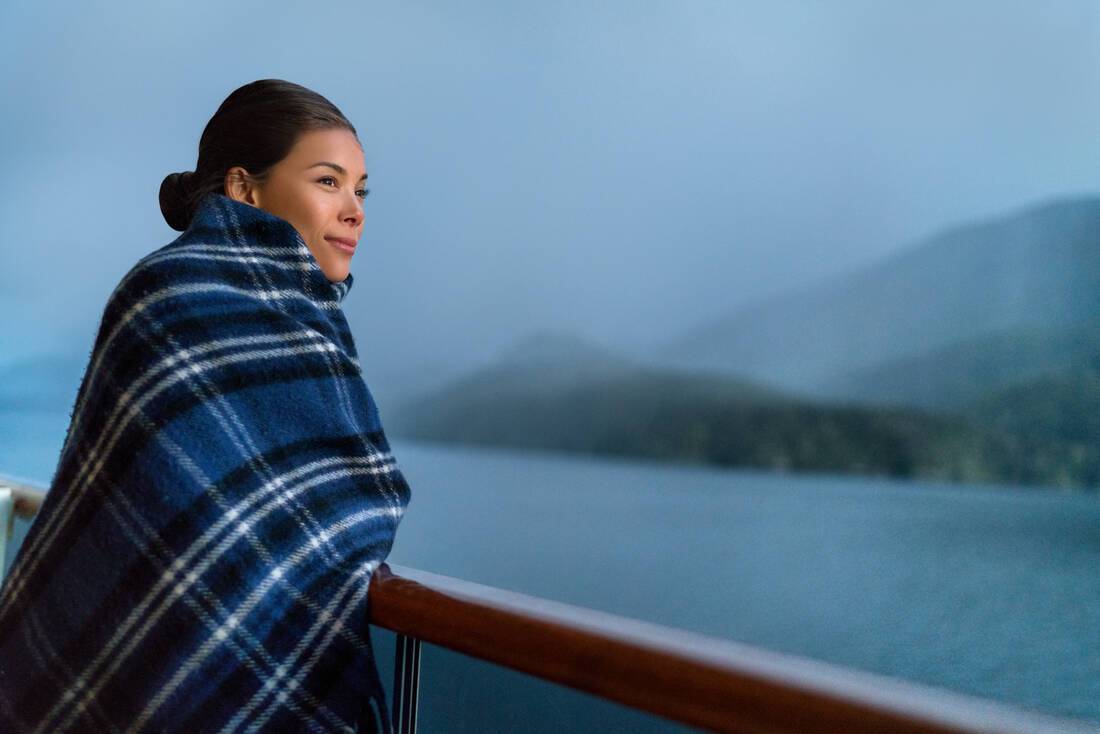 Woman keeping warm on a cruise ship