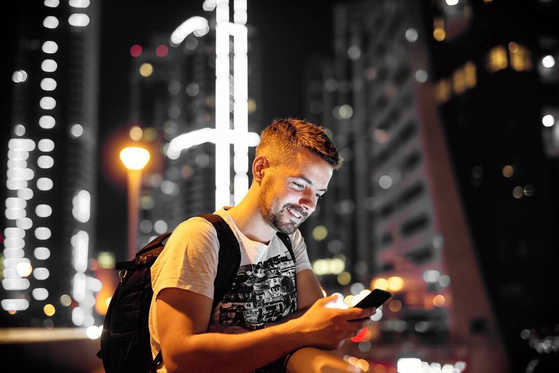 Man looking at phone in city
