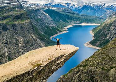 Girl standing on Trolltunga in Stavanger