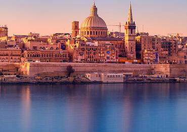 The sun rising over Valletta