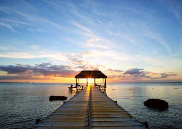 Jetty silhouette against beautiful sunset in Mauritius Island