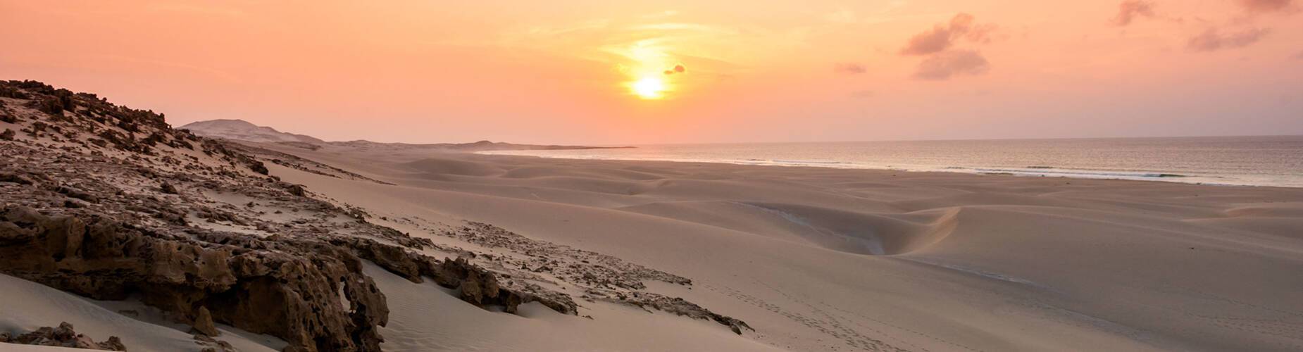 The sun setting over Chaves Beach in Praia